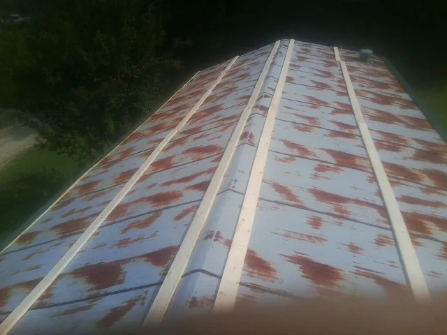 Rusted metal roof panels with new wood purlins before replacement — Storm Damage Roof Repair in Aromas by Roofing Brothers